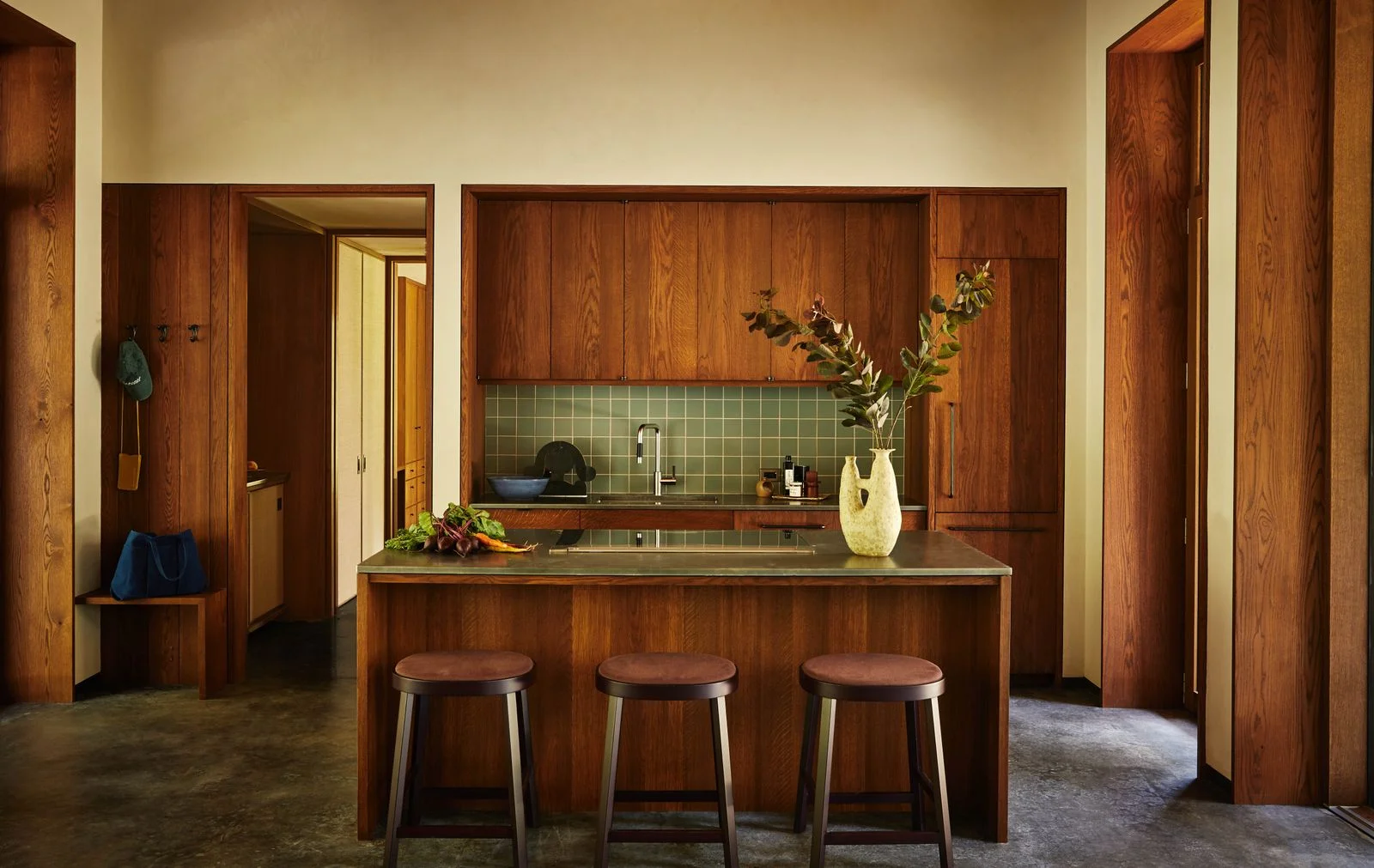 Image may contain Indoors Interior Design Wood Hardwood Stained Wood Bar Stool Furniture Sink Kitchen and Plant