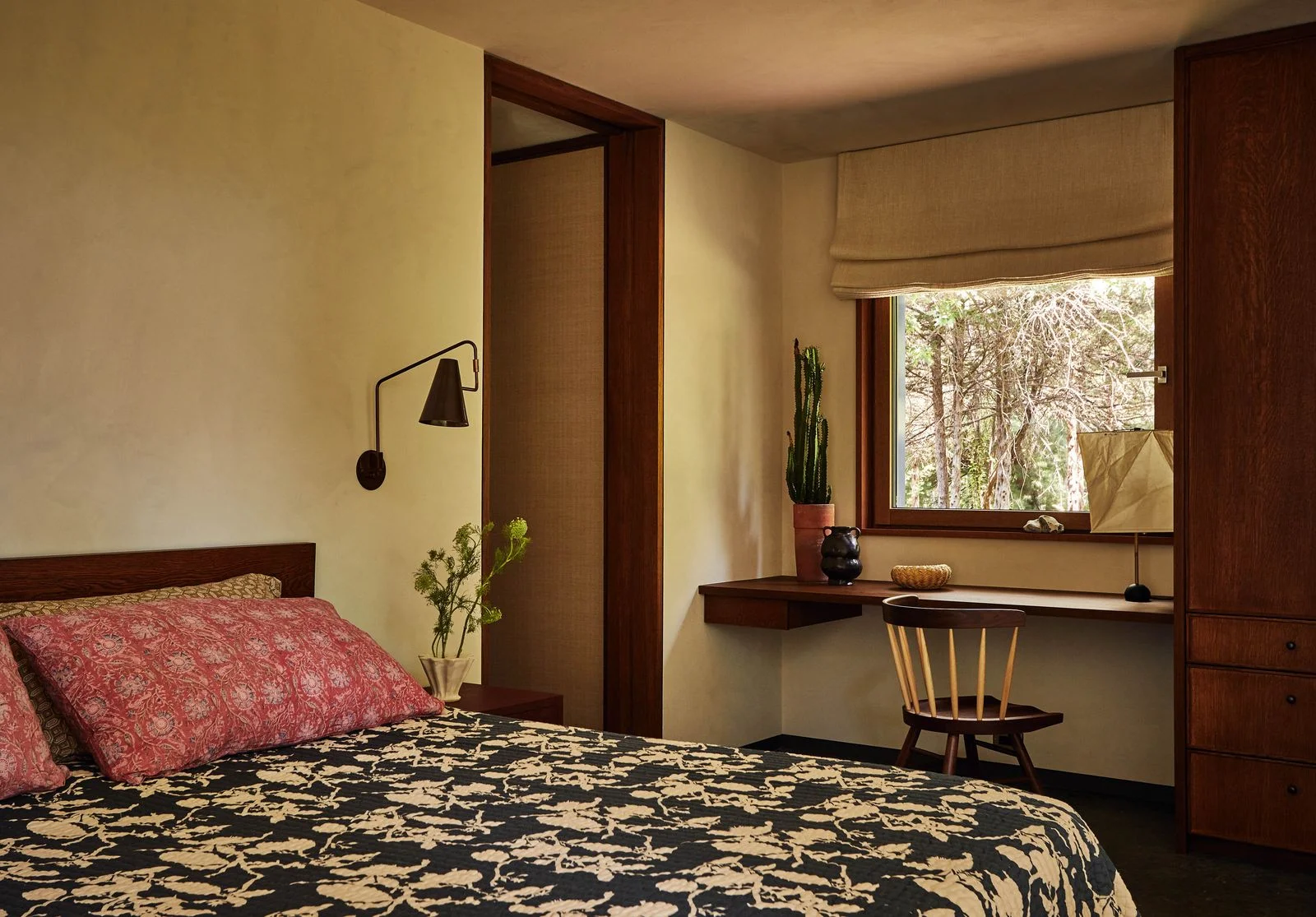 Image may contain Indoors Interior Design Home Decor Plant Chair Furniture Door Lamp Corner Bed Bedroom and Room