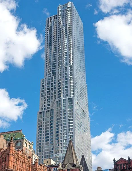 tall skyscraper under partly cloudy skies