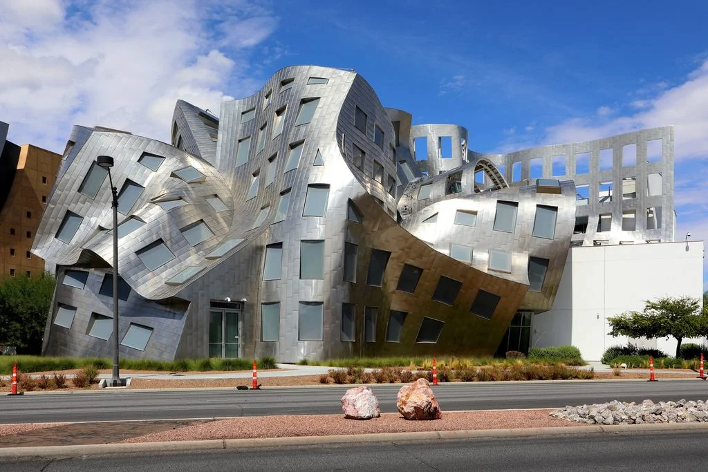 modern silver building located next to a street