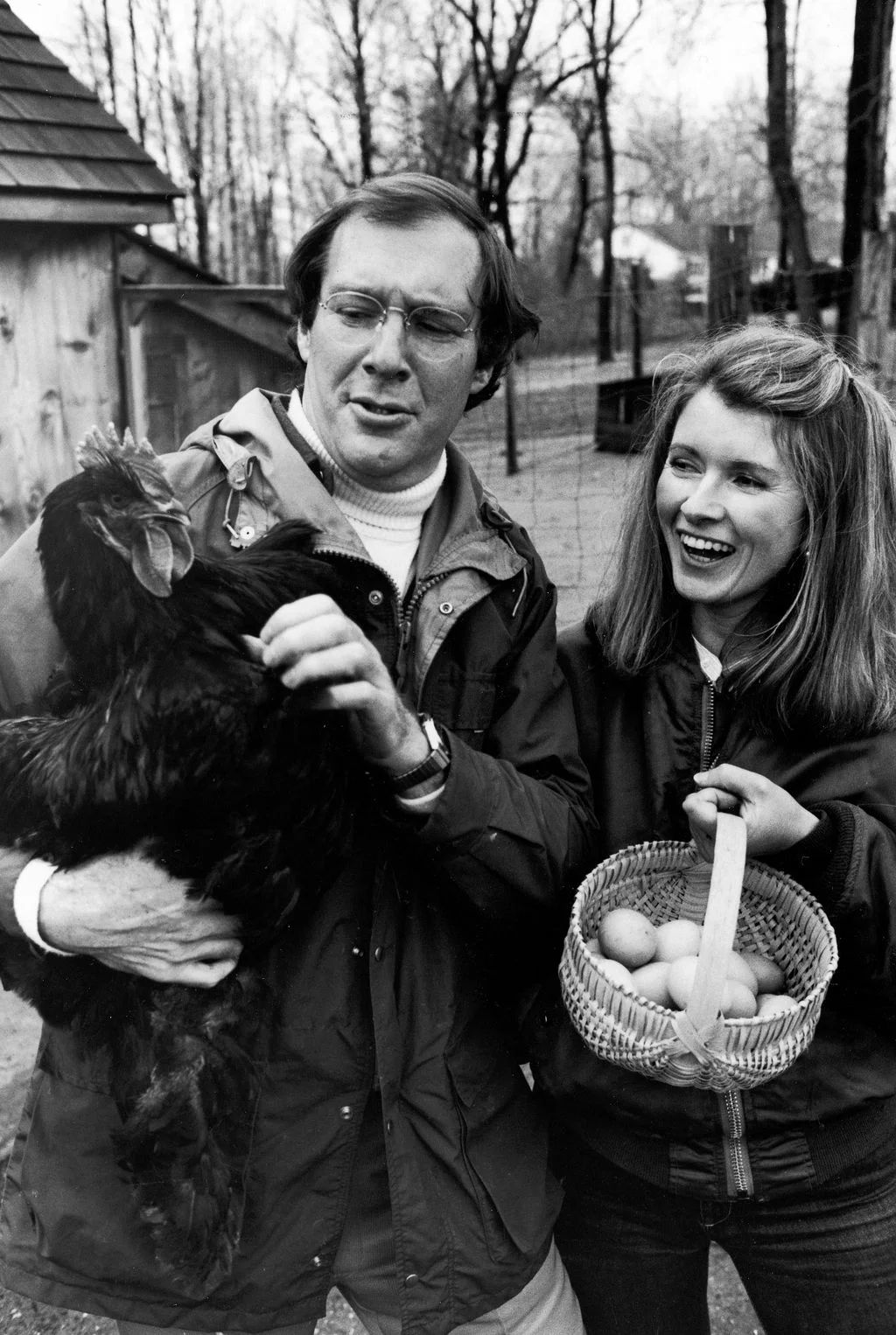 blackandwhite photo of Martha Stewart holding basket filled with eggs right Andy Stewart holding chicken