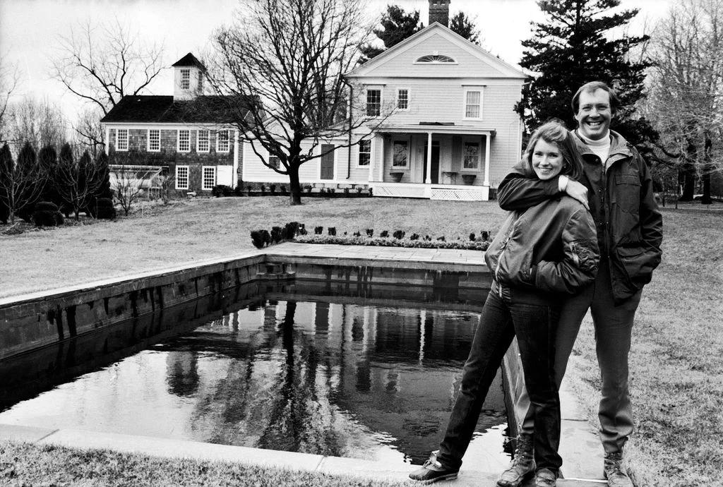 blackandwhite photo of Martha Stewart standing poolside at her Turkey Hill farm Andy Stewart left with arm around...