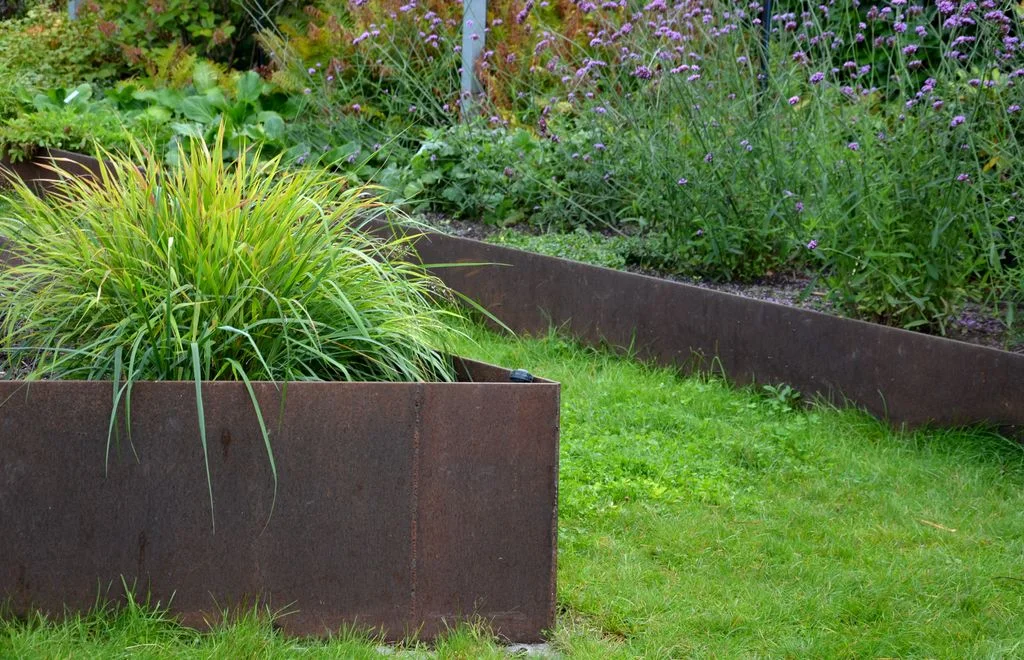 Wood is definitely not the only option. Consider alternative materials to create raised garden beds to contain your...