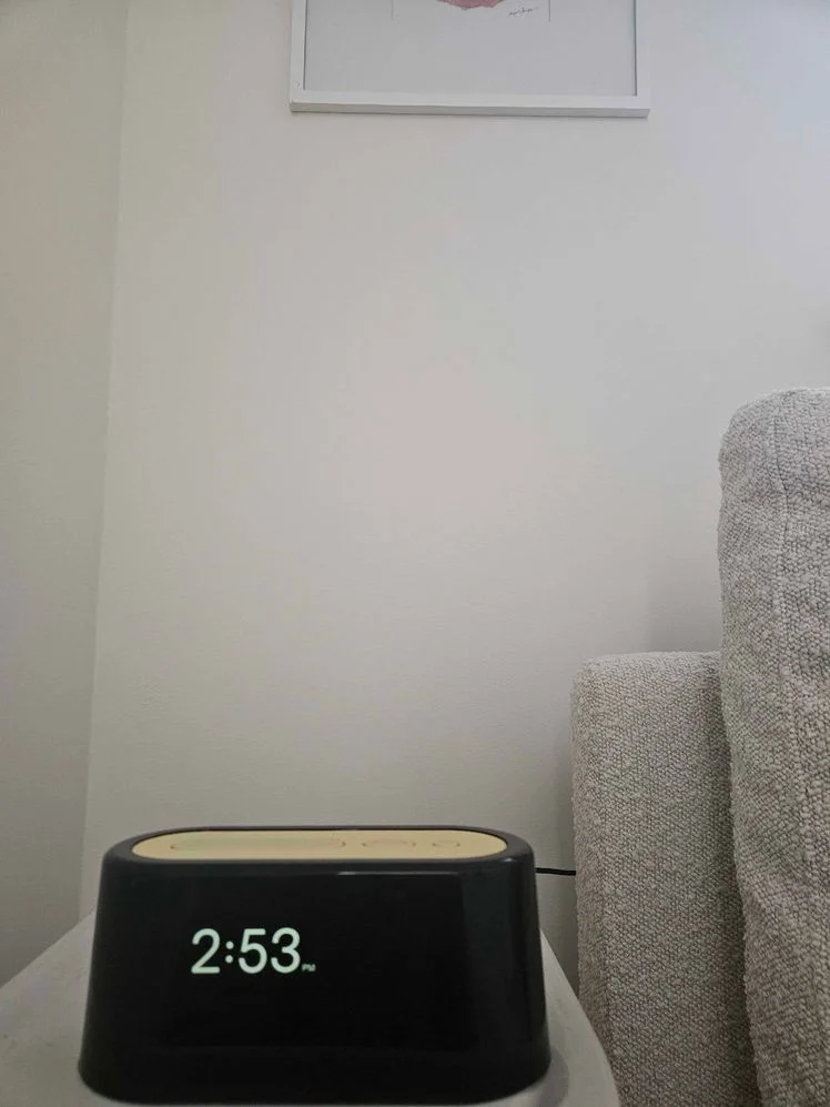 Alarm clock on a side table.