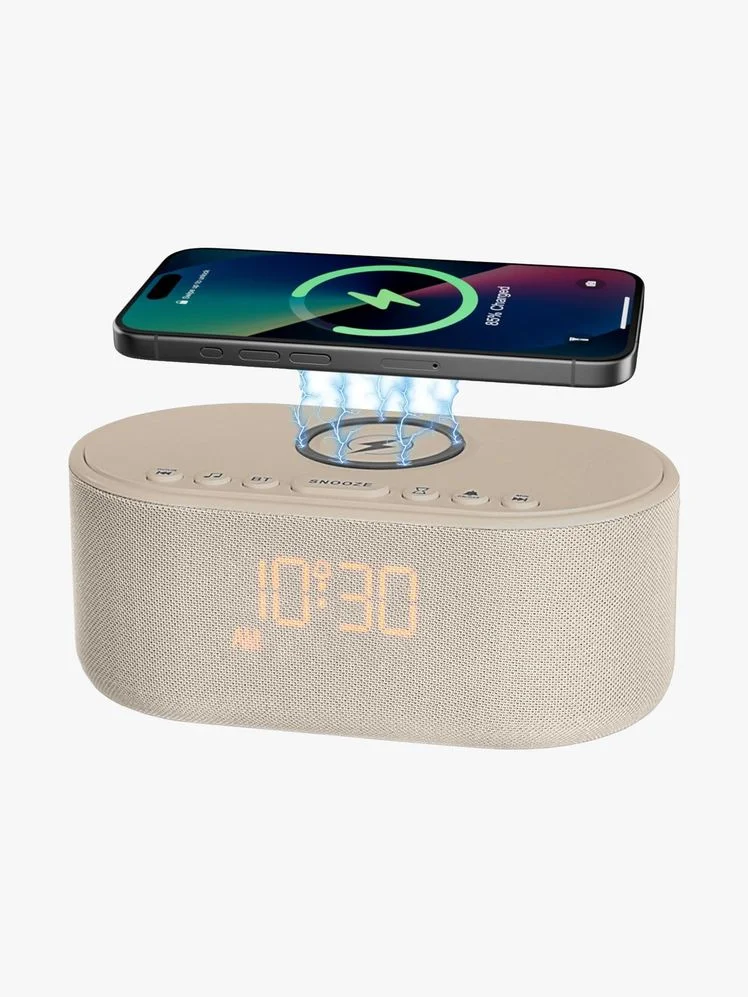 Oval shaped alarm clock with a wireless charging port on the top of it.