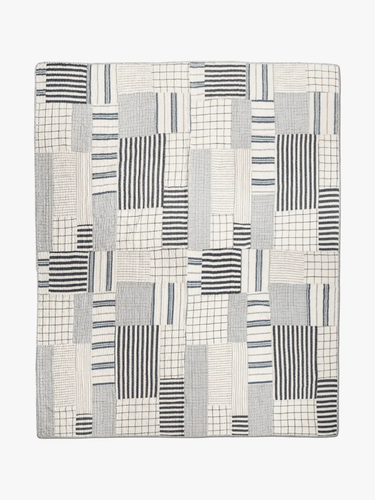 Image may contain: Home Decor, Rug, Linen, Quilt, Clothing, and Shirt