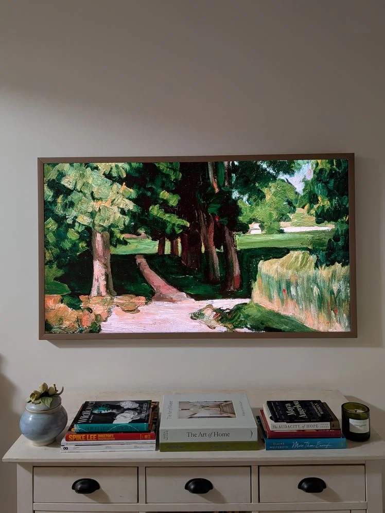 TV with art on the screen mounted on the wall.