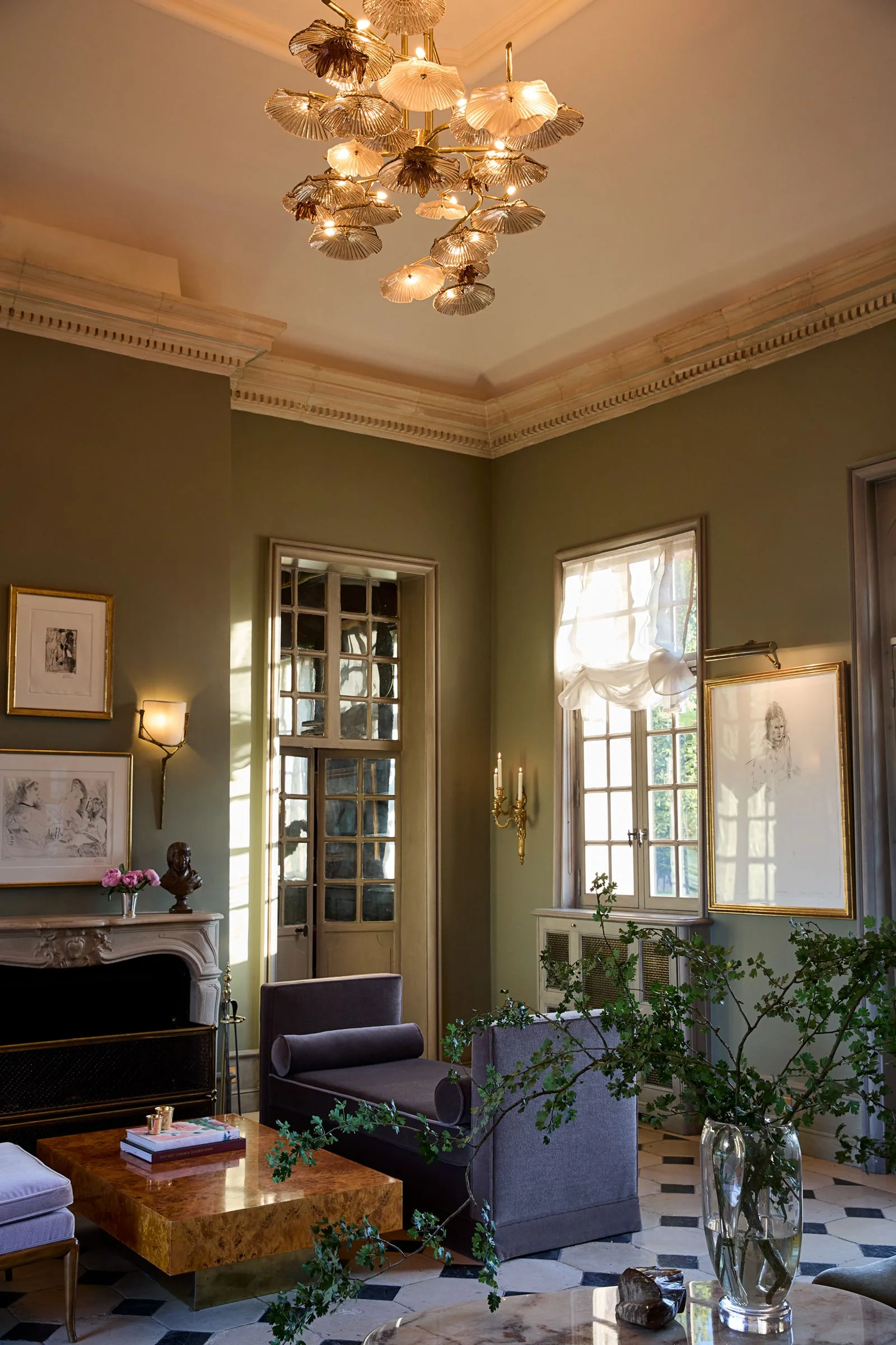 Image may contain Chandelier Lamp Plant and Person