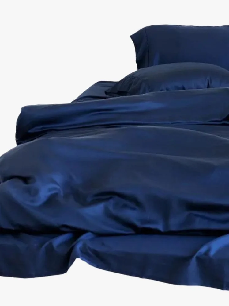 Image may contain: Furniture, Bed, Bed Sheet, and Person