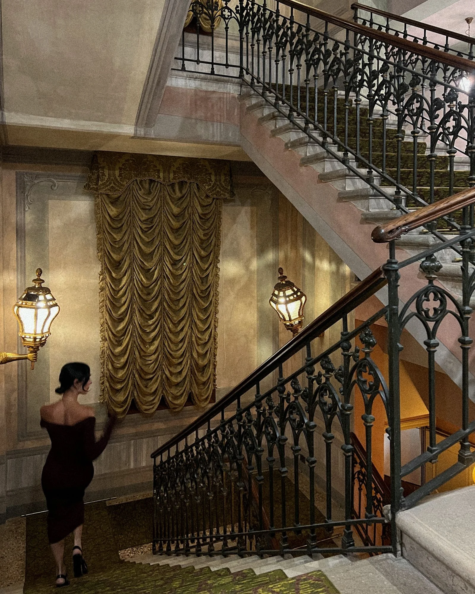 Image may contain Architecture Building House Housing Staircase Adult Person Foyer Indoors Lamp and Handrail