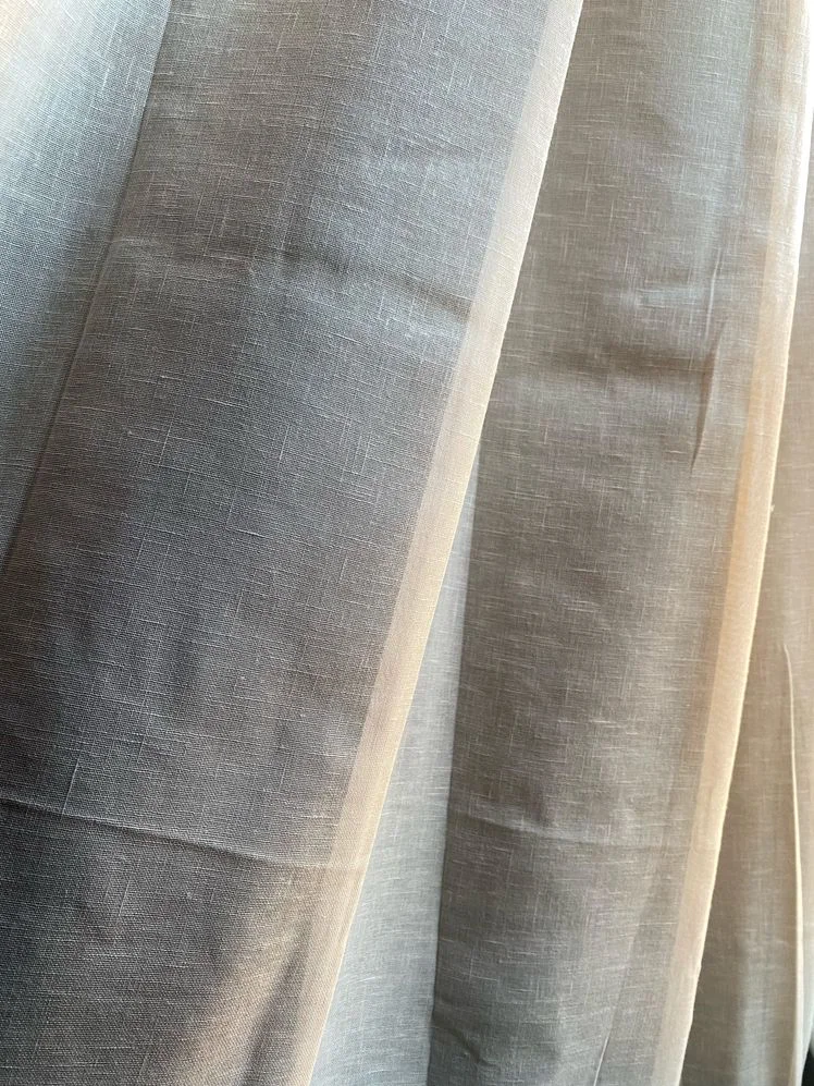Closeup of the texture of beige blackout curtains.