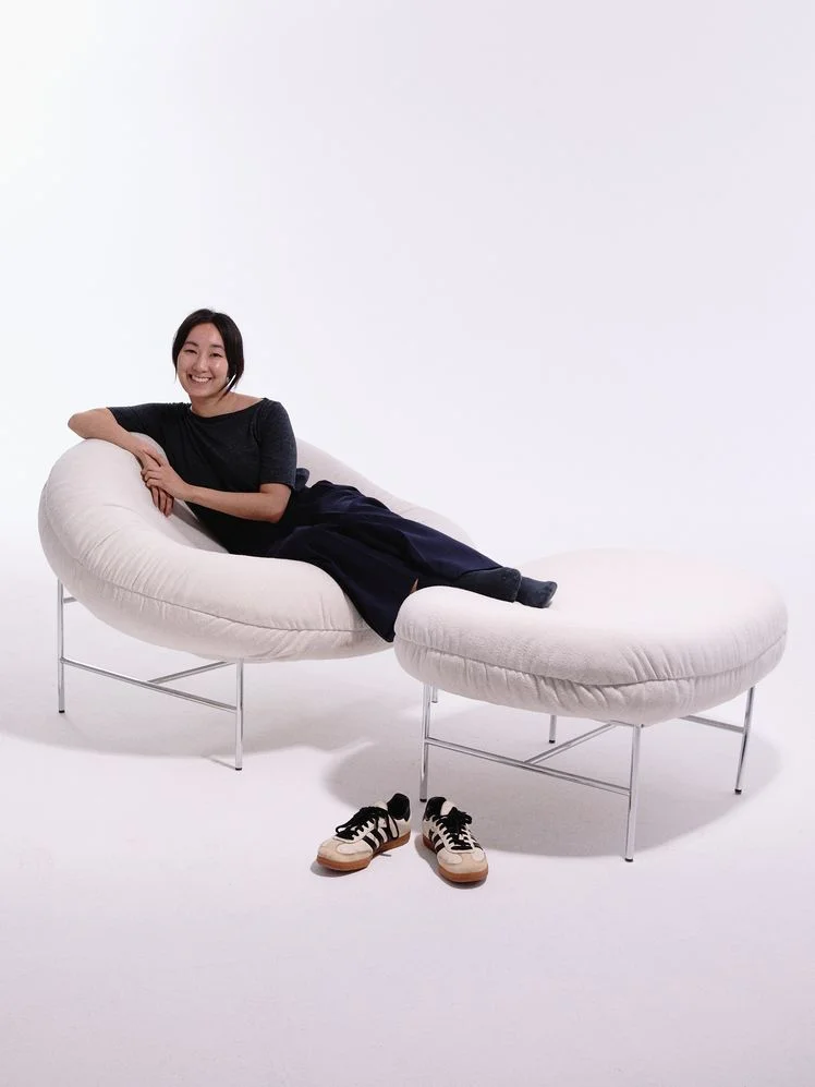 Person lounging on the Knoll Willo Perron Bun Chair and ottoman.