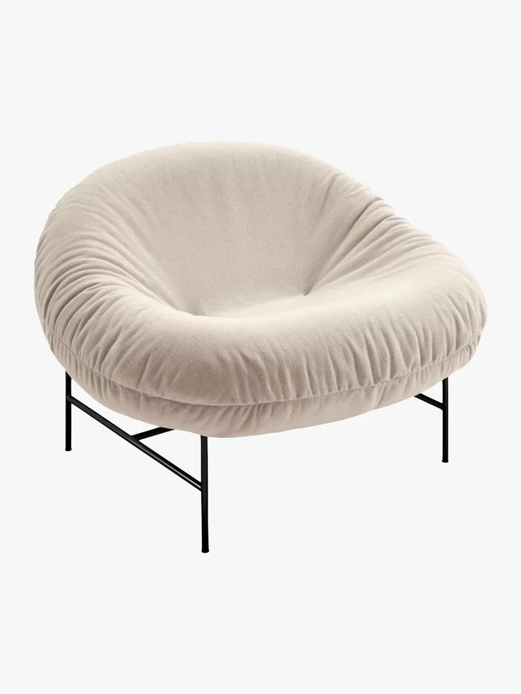 Accent chair with metal frame and white puffy cushion seat.