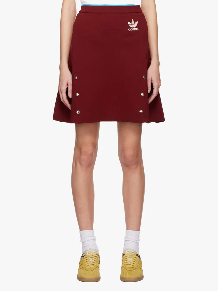 Image may contain: Clothing, Skirt, Miniskirt, Person, Footwear, and Shoe