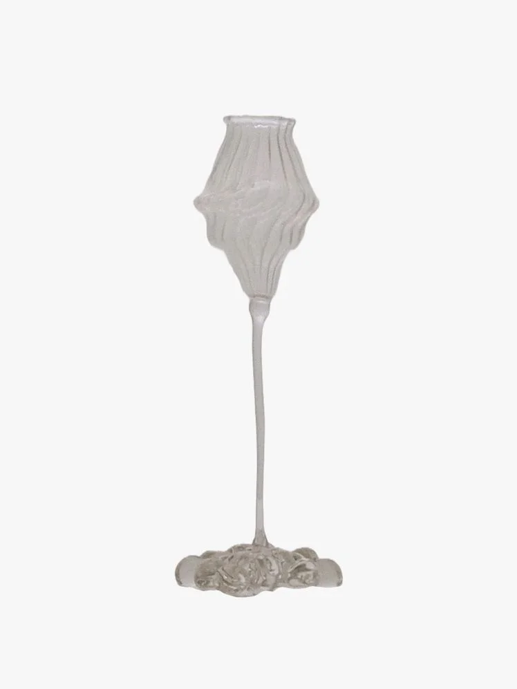 Irregular glass with fluted design that features a sculpted goblet on a slim, delicate stem that emerges from bubbly base.