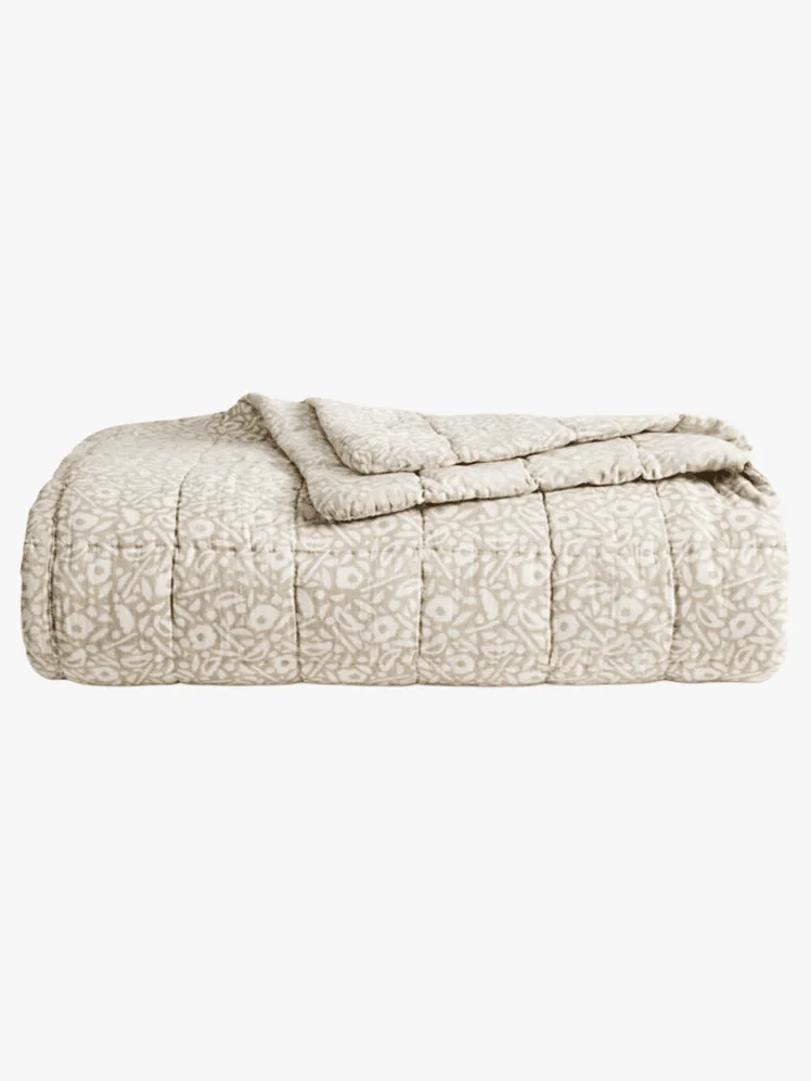 Gray and white patterned quilt folded