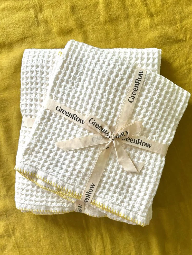 Two towels in a stack with a bow wrapped around them.