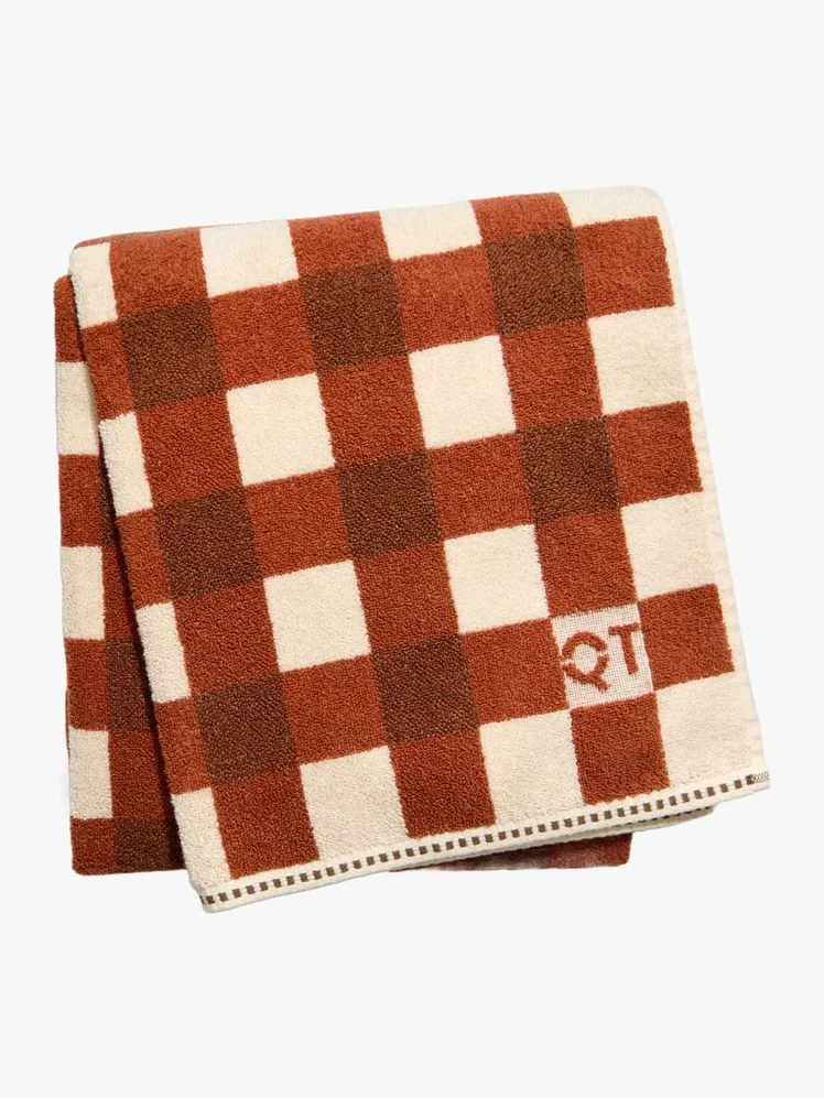 Bath towel with brown checkered design.