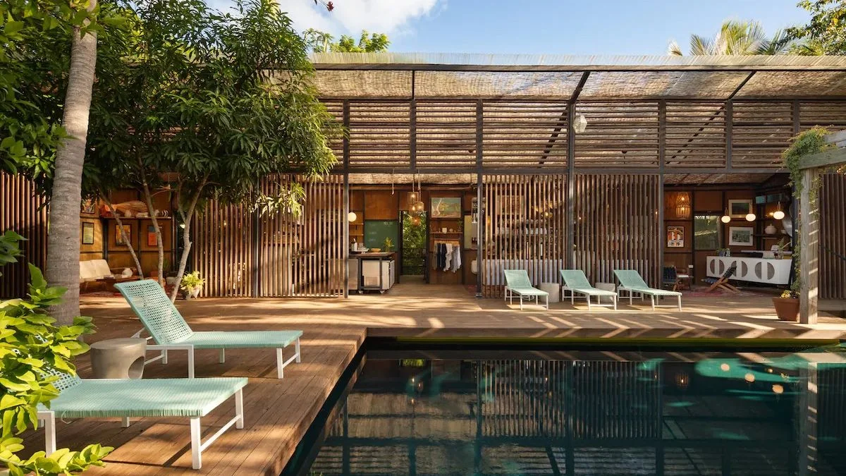 Image may contain Indoors Interior Design Architecture Building Hotel Pool Water Resort Swimming Pool and Chair