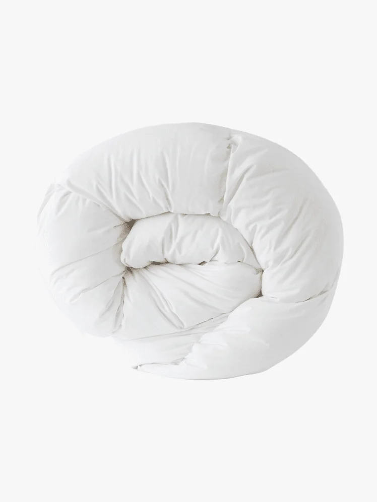 Rolled up white comforter.