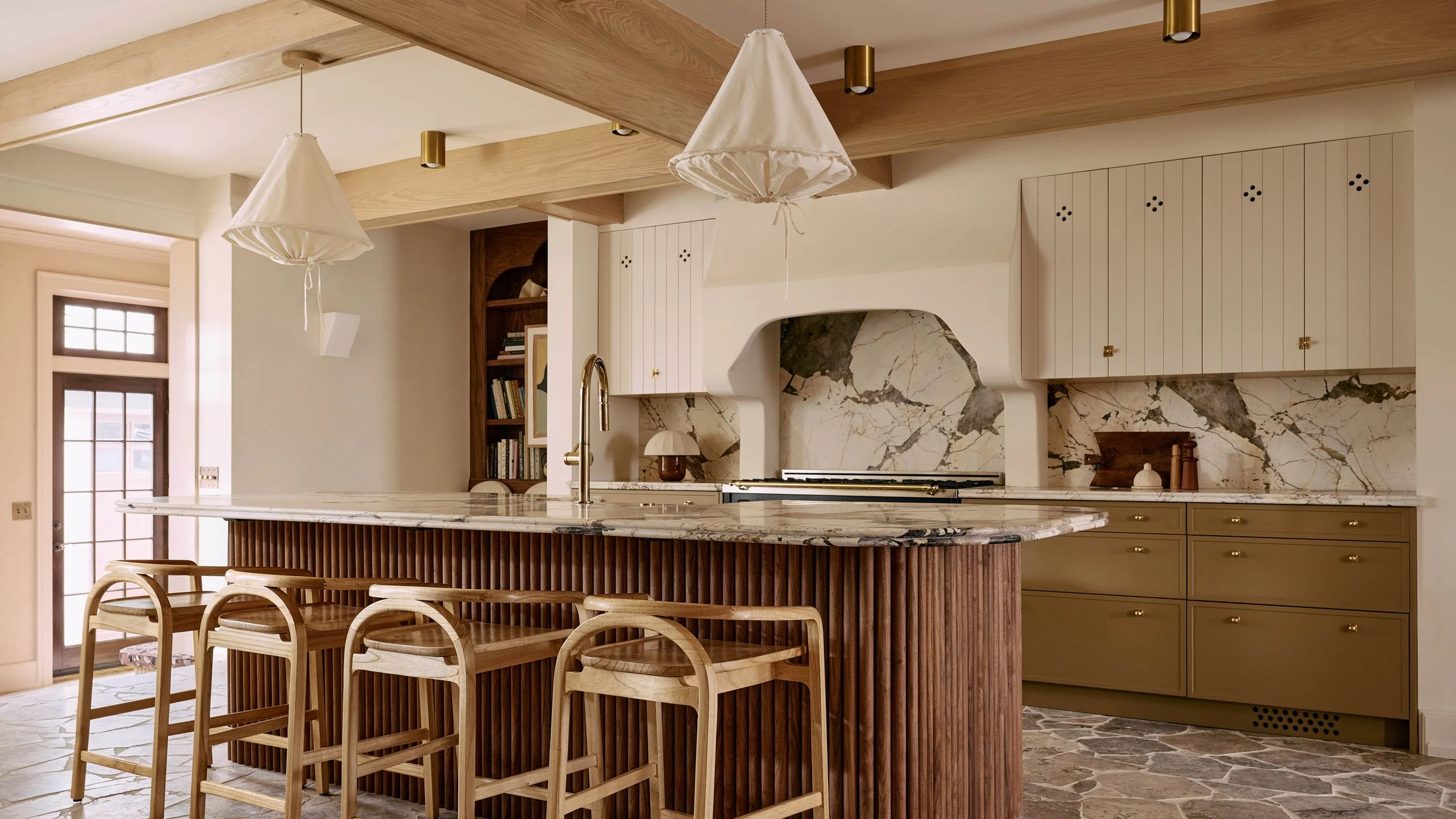 Image may contain Indoors Interior Design Kitchen Kitchen Island Sink Sink Faucet Floor Lamp Chair and Furniture