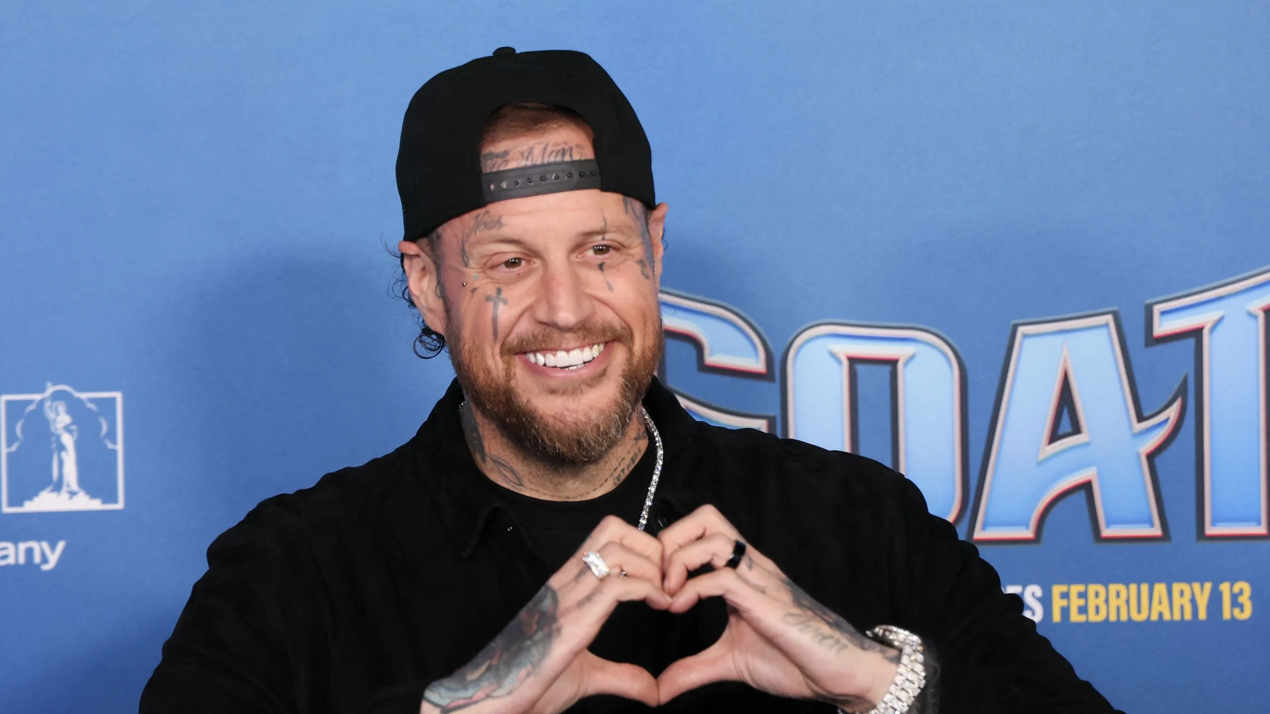 Image may contain Jelly Roll Adult Person Symbol Face Head Skin and Tattoo