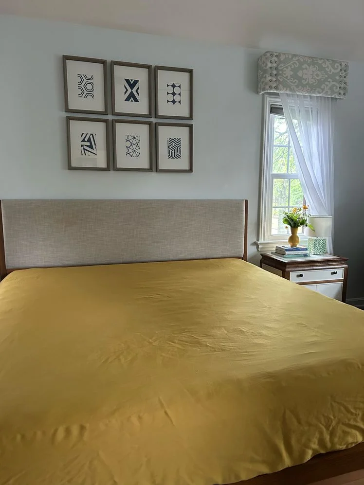 Bed made with a yellow fitted sheet.