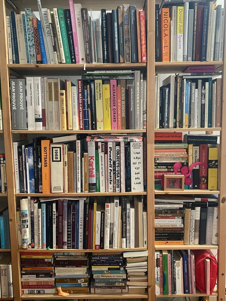 Pine wood bookshelf stuffed with books.