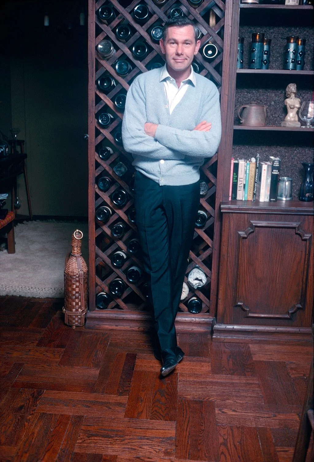 Image may contain Johnny Carson Person Standing Adult Mortar Shell Weapon Alcohol Beverage Liquor and Furniture