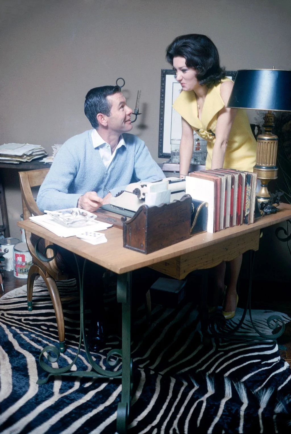 Image may contain Johnny Carson Sherri Martel Furniture Table Desk Face Head Person Photography Portrait and Lamp