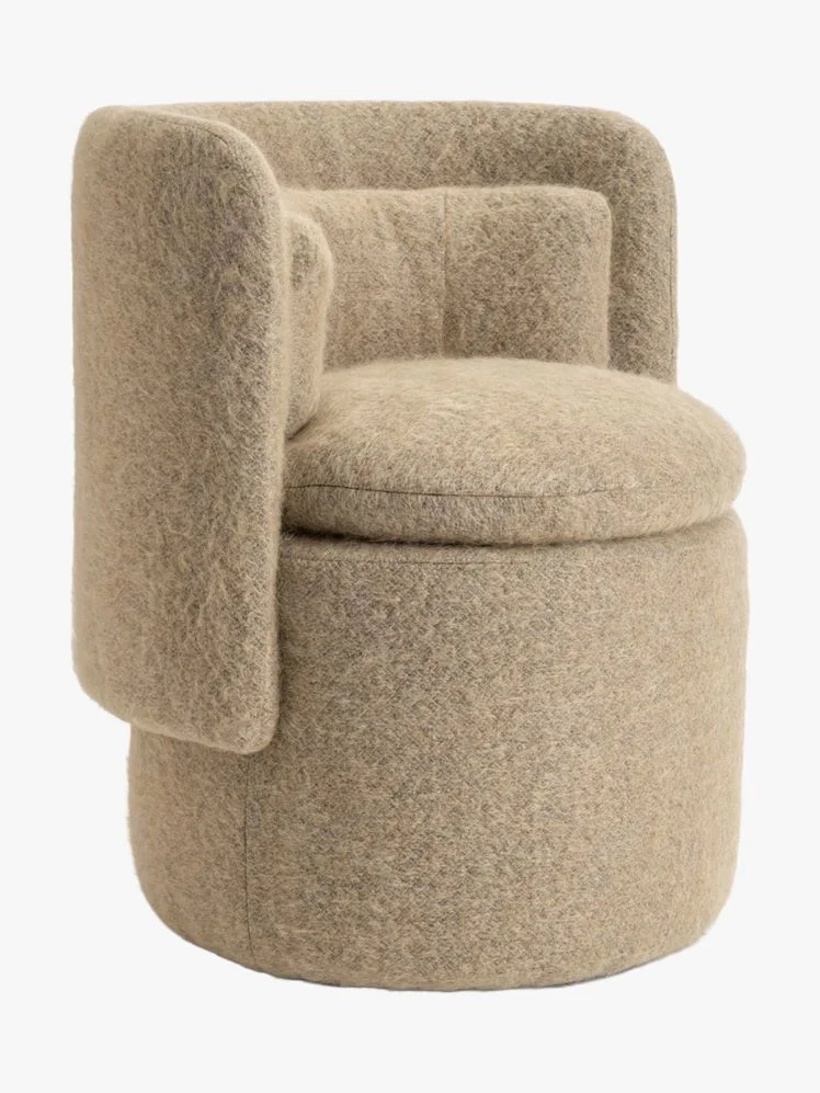 Barrel chair with boucle upholstery.