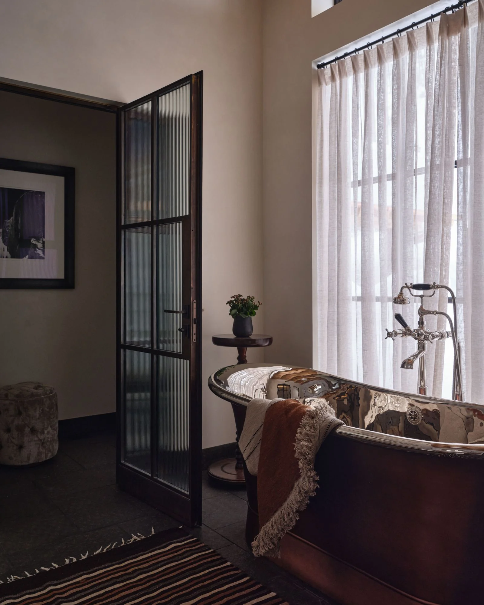 Image may contain Bathing Door Bathtub Person Tub Art Painting Plant Architecture Building and Housing