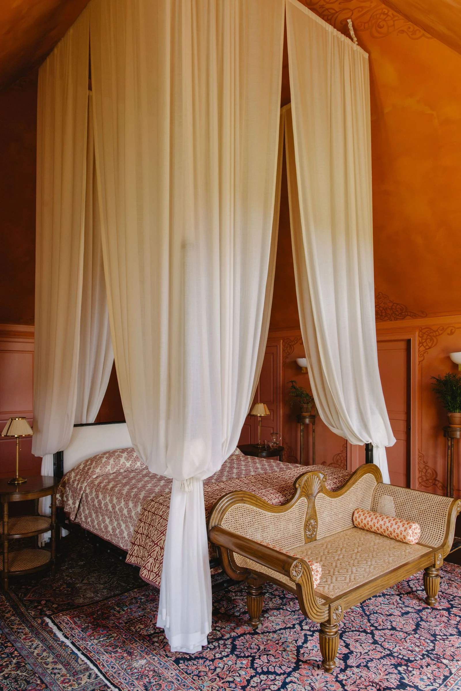 Image may contain Furniture Bed Bedroom Indoors Room Lamp Canopy Bed Plant and Bench