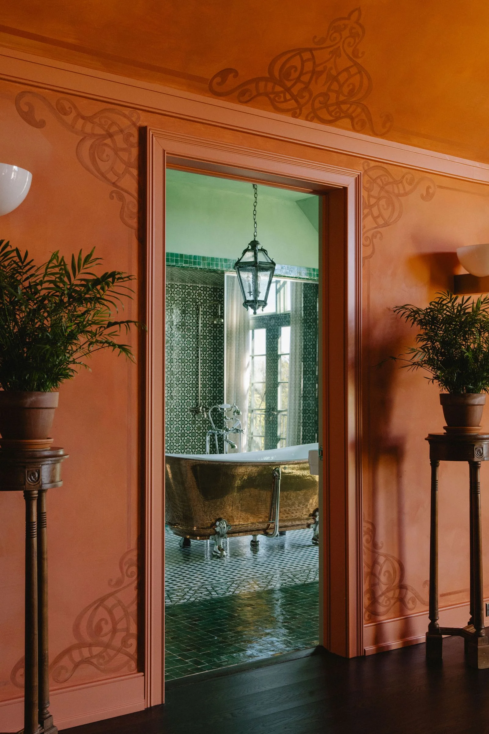 Image may contain Indoors Interior Design Door Plant Potted Plant Lamp Bathing Bathtub Person and Tub