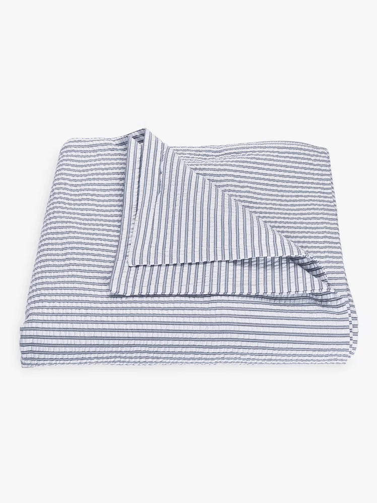 A blue and white striped duvet cover 