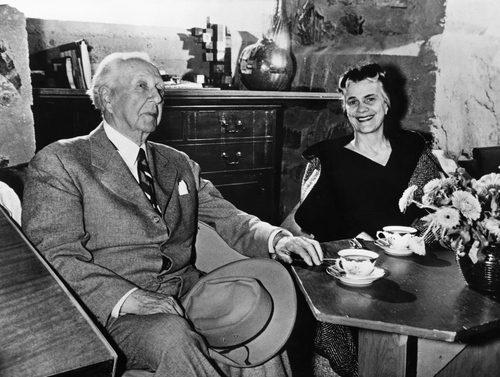 Image may contain Human Person Furniture Tie Accessories Accessory Table Suit Clothing Coat Overcoat and Apparel