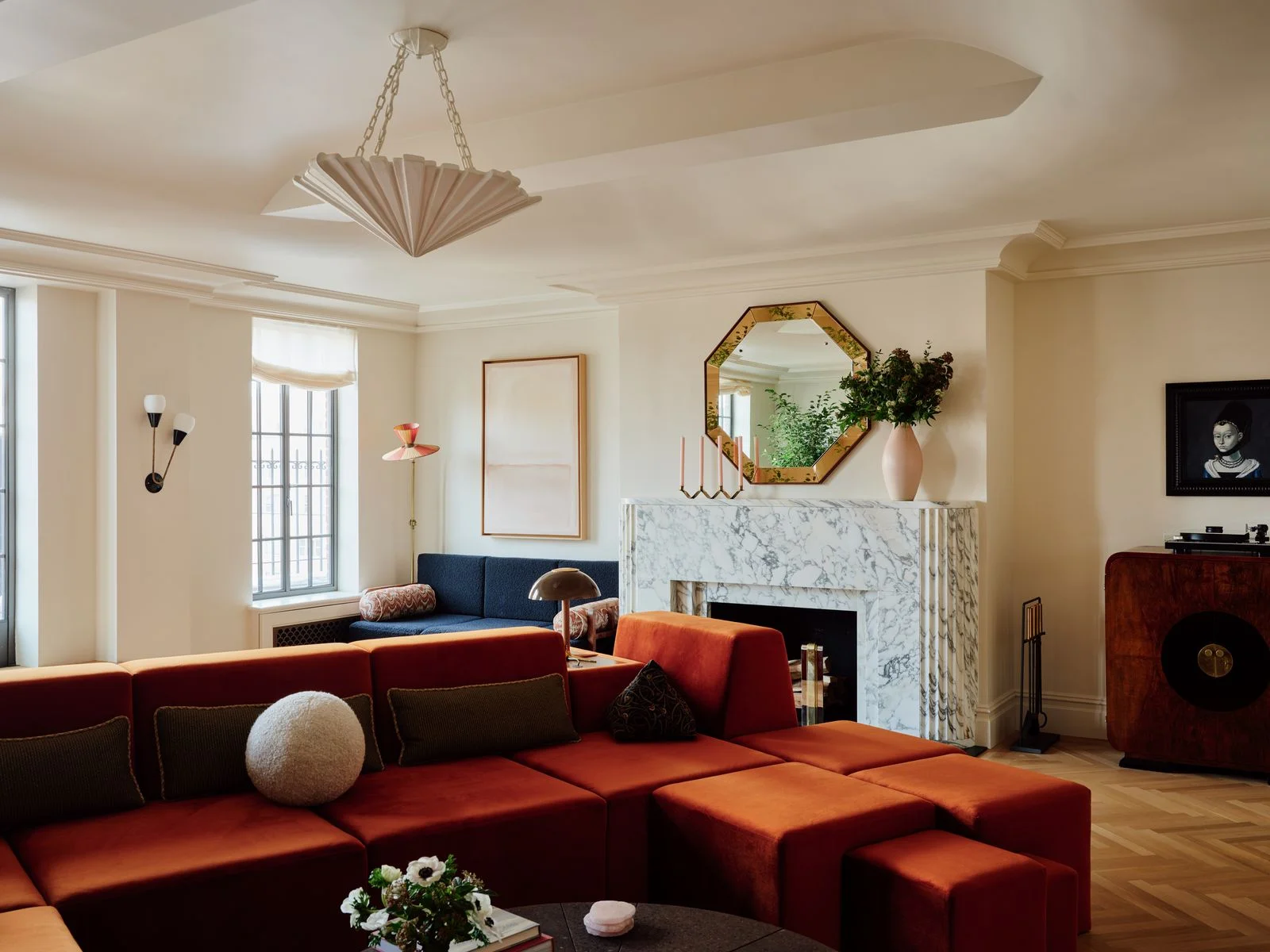 Image may contain Home Decor Couch Furniture Architecture Building Indoors Living Room Room Cushion and Chandelier