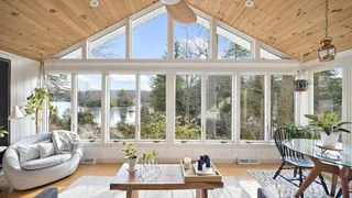 Image may contain Indoors Interior Design Plant Lamp Furniture Table Home Decor Rug Chair Couch and Coffee Table