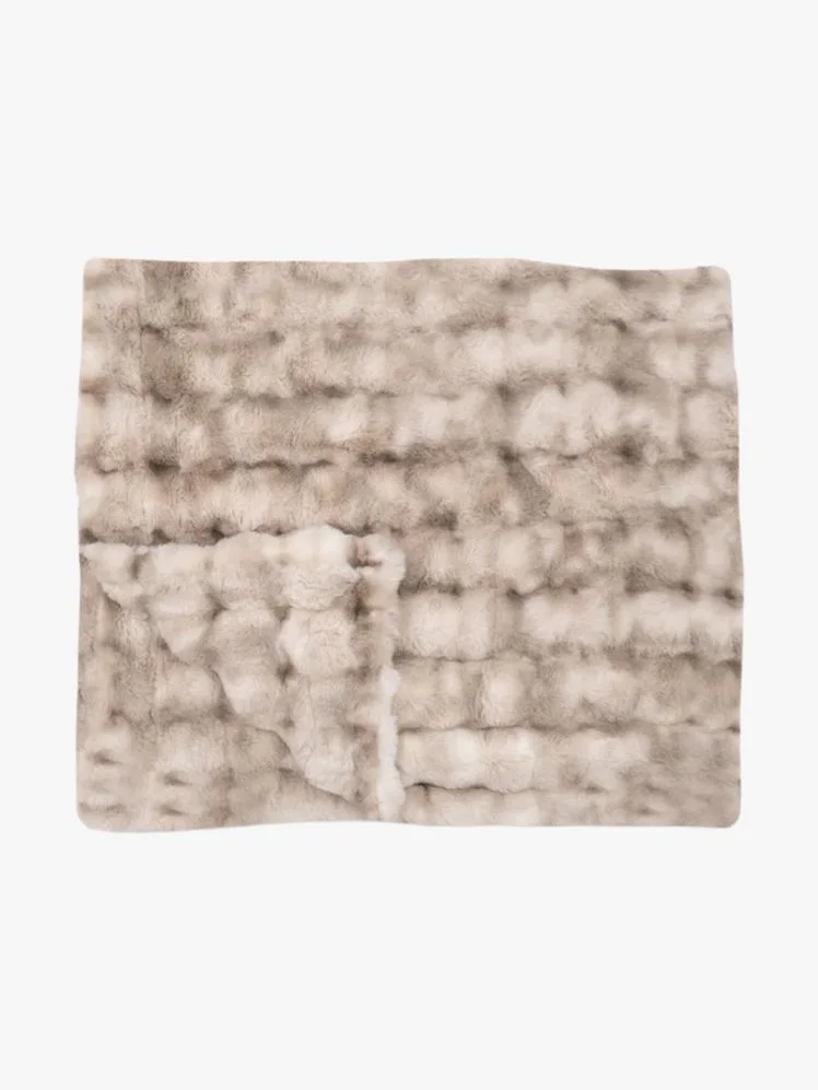Weighted blanket in dusky whites and sandy hues.