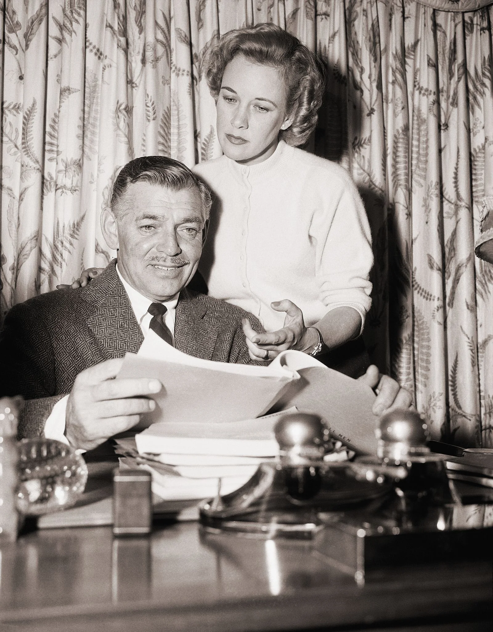 Image may contain Clark Gable Phyllis Thaxter Furniture Table Face Head Person Photography Portrait and Adult