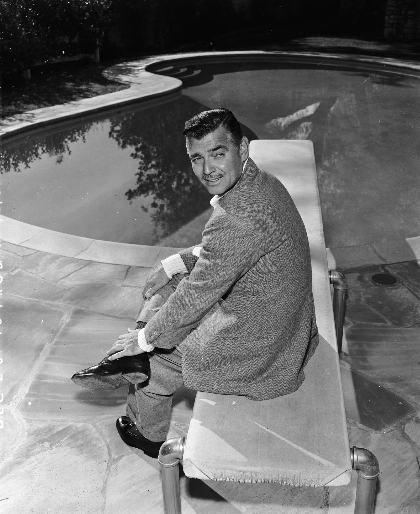 Image may contain Clark Gable Clothing Footwear Shoe Coat Photography Face Head Person Portrait and Sitting