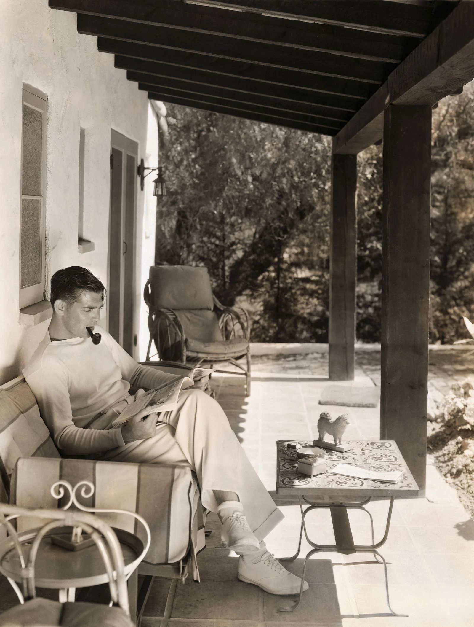 Image may contain Clark Gable Person Sitting Chair Furniture Architecture Building House Housing Porch and Adult