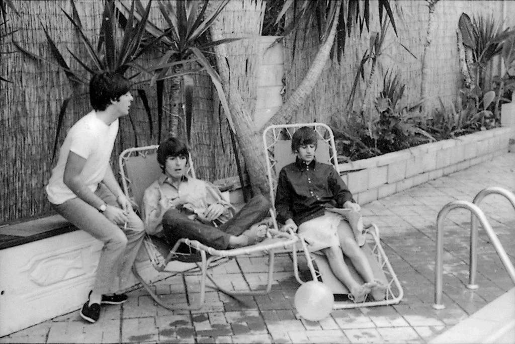 The Beatles  Paul George and Ringo sitting along pooldeck