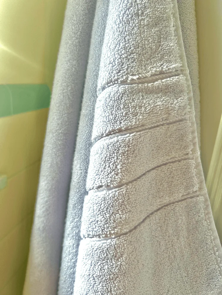 Closeup of the stitching on a bath towel.