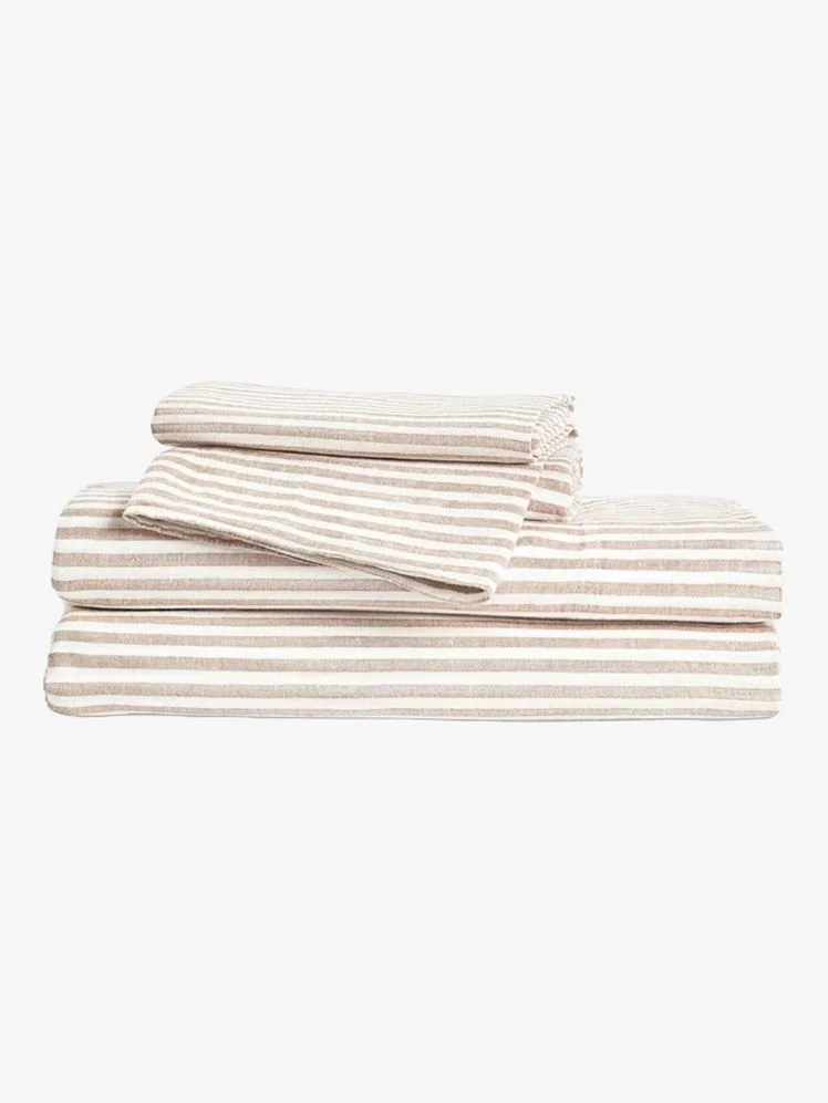 Stack of folded brown and beige striped sheets.