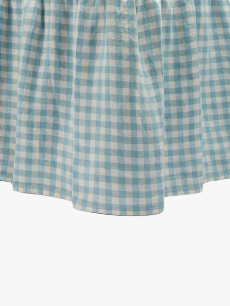 Image may contain: Clothing, Skirt, Tablecloth, and Furniture