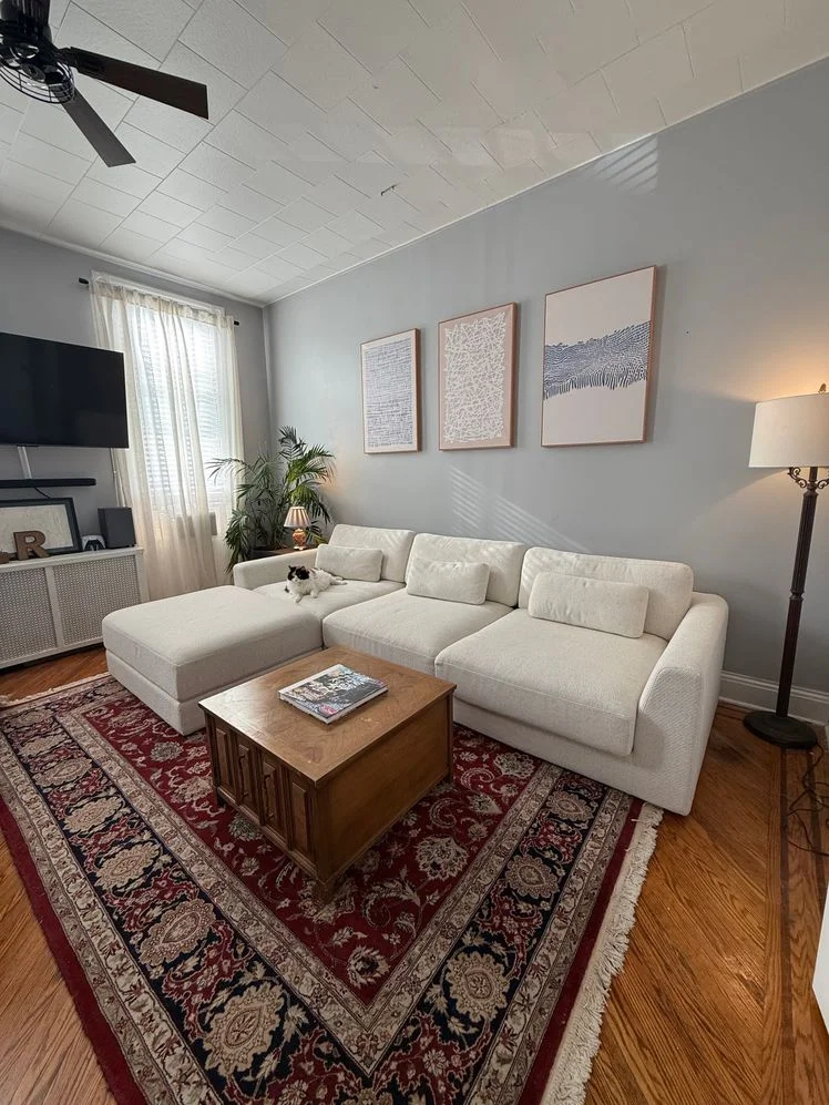 White couch and ottoman in living room.