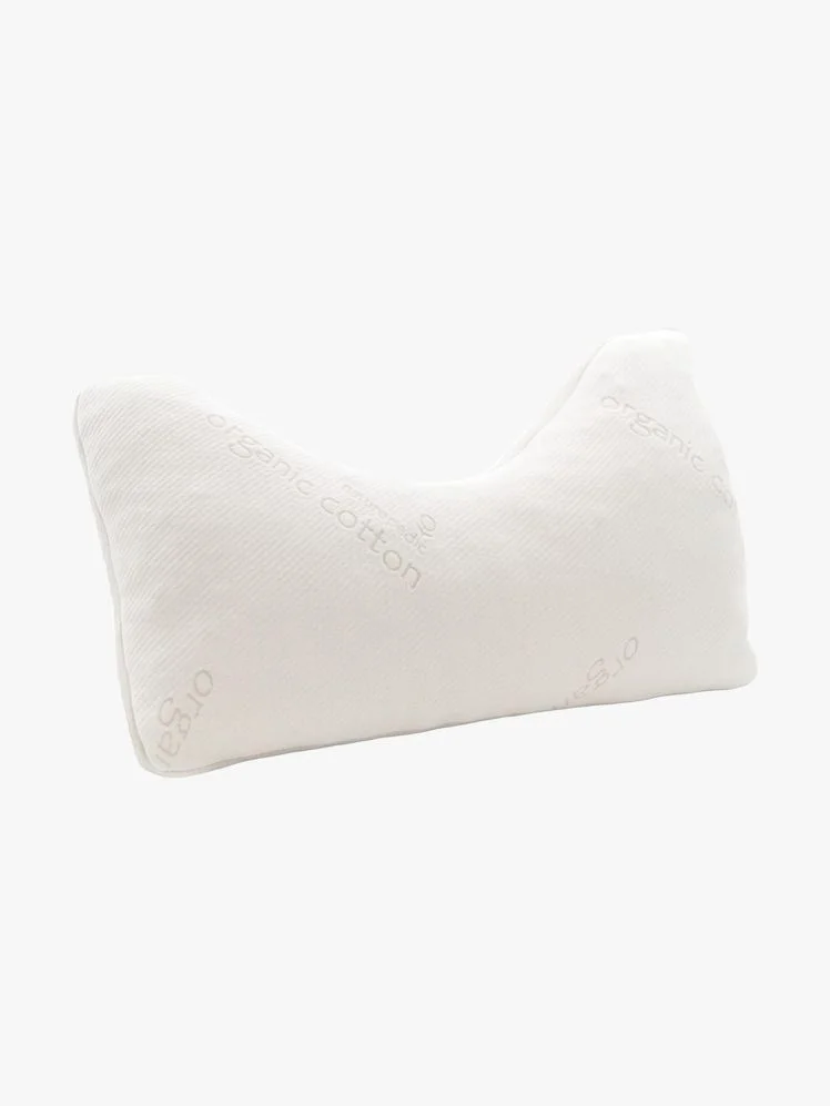 Bed pillow with a straight side and a curved side.