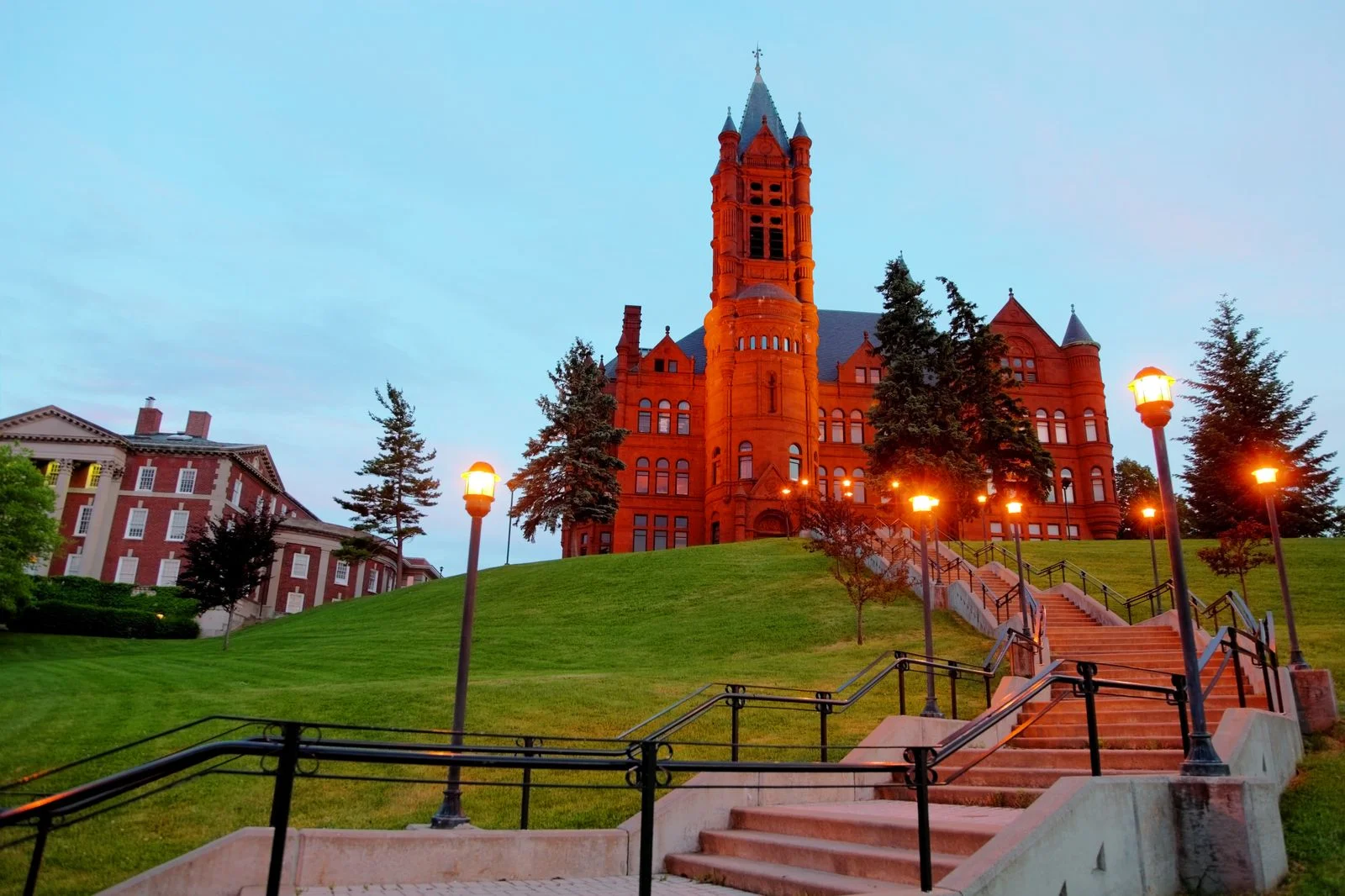 Image may contain Architecture Building Campus Grass Plant Clock Tower Tower Bell Tower Arch Lawn and Gothic Arch