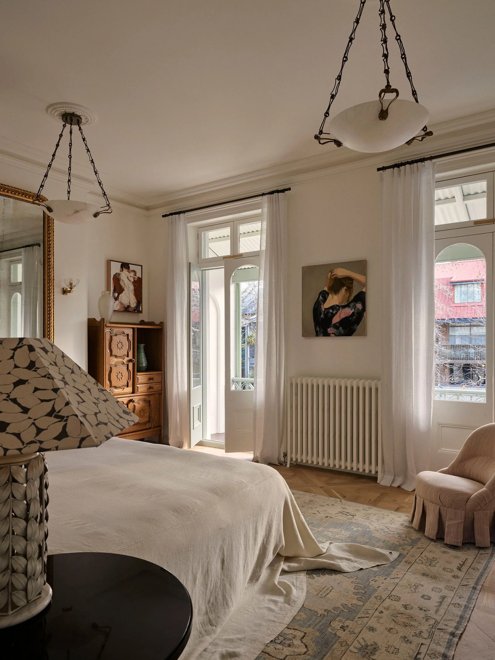 Image may contain Home Decor Lamp Adult Person Art Painting Chair Furniture Bed Window and Indoors